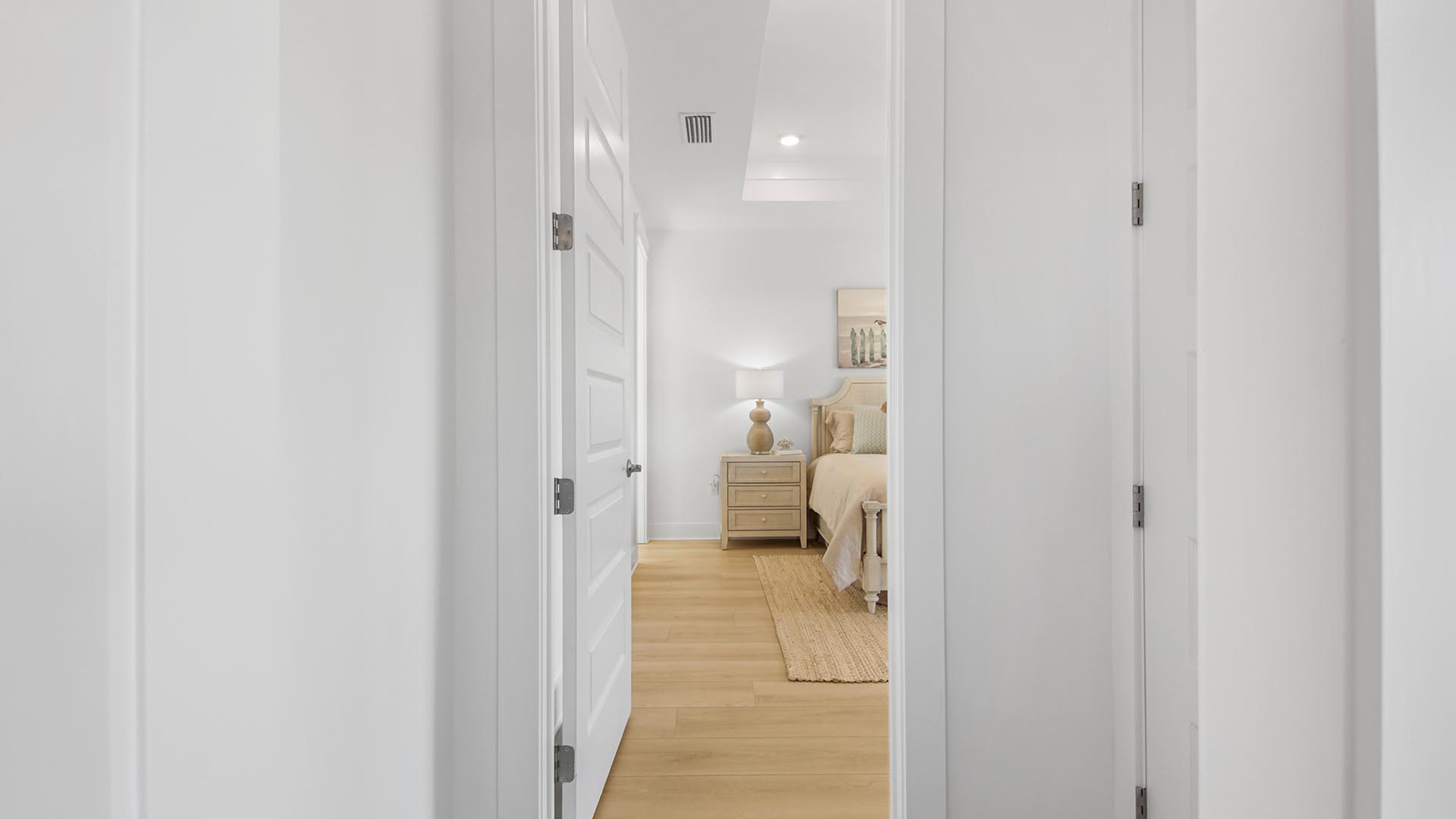 The primary bedroom features beautiful flooring