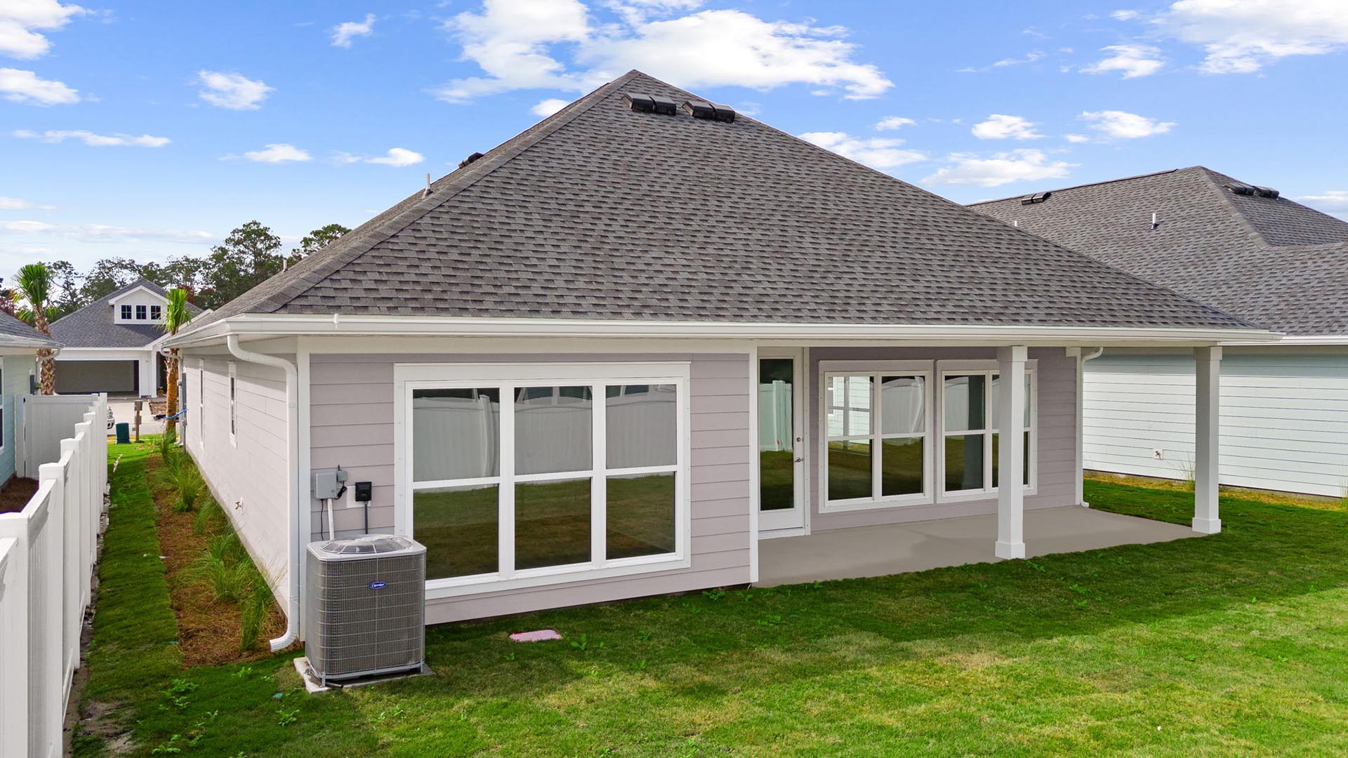 The back of the home has expansive windows allowing for natural light