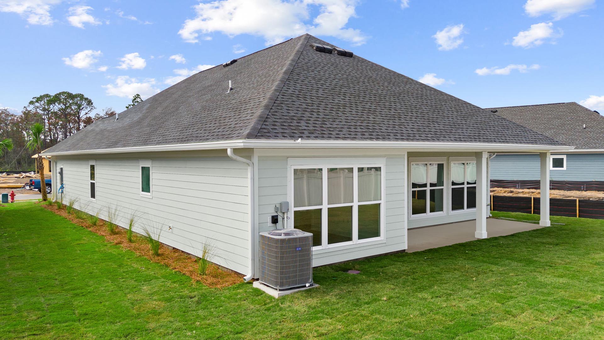 The back of this home has spanning windows that allow for natural light