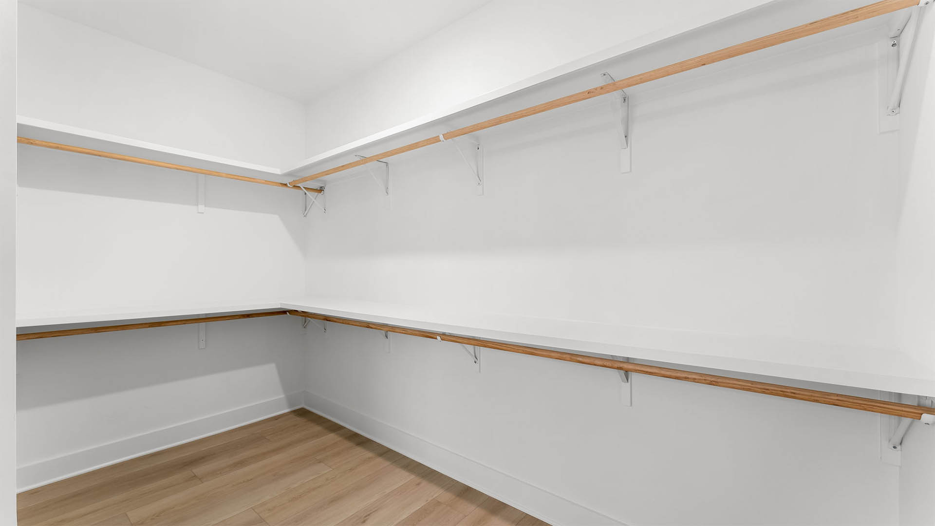 The primary closet has wood shelving for storage