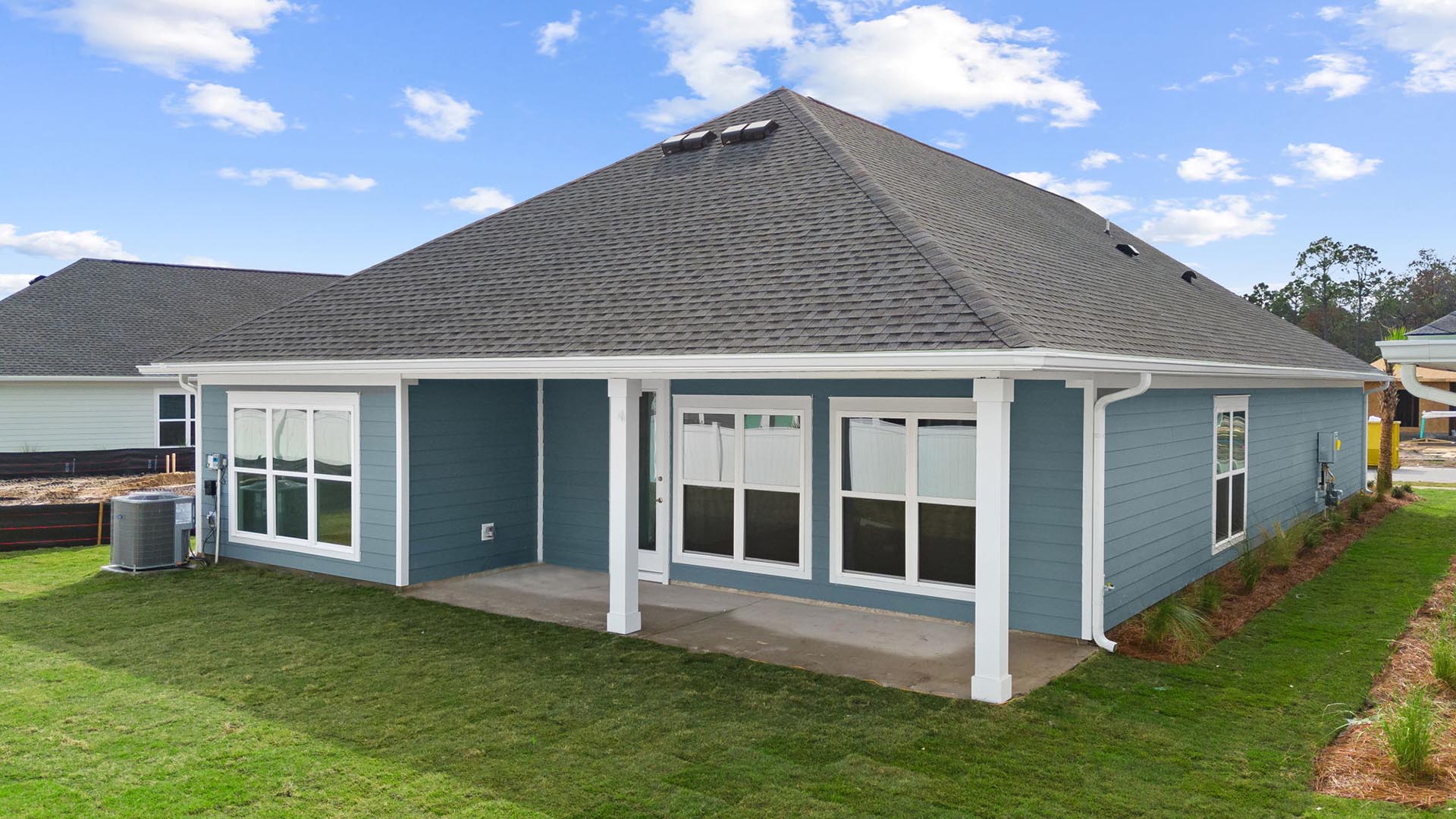 The back of the home has a covered patio