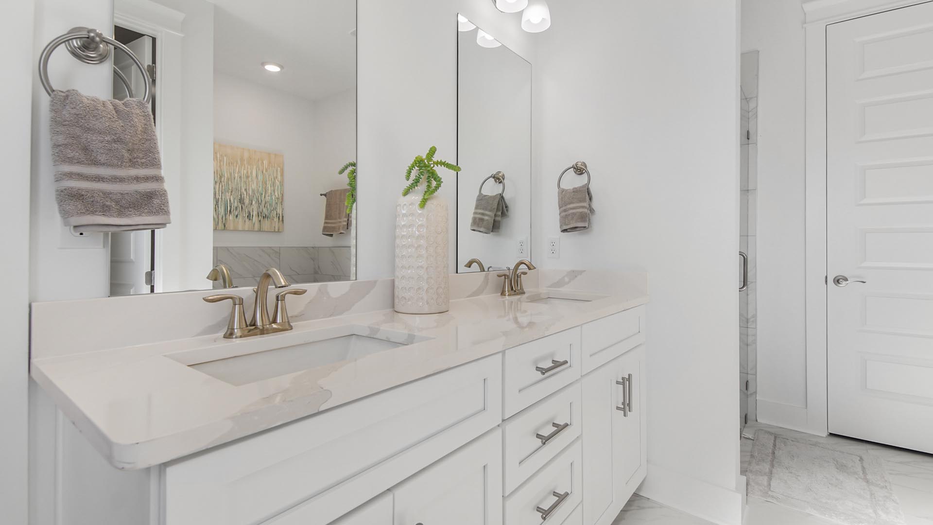 The vanity in the private bathroom features dual sinks and lower cabinetry for all of your toiletry storage needs