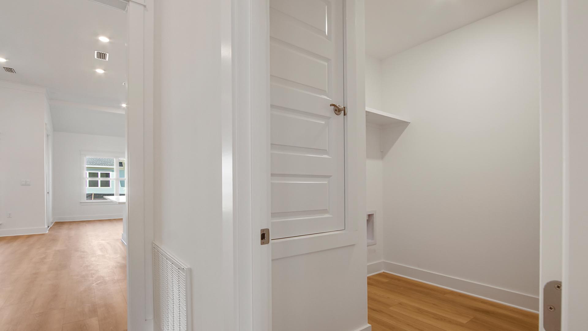 The laundry room is located off the main entry hall leading to living area