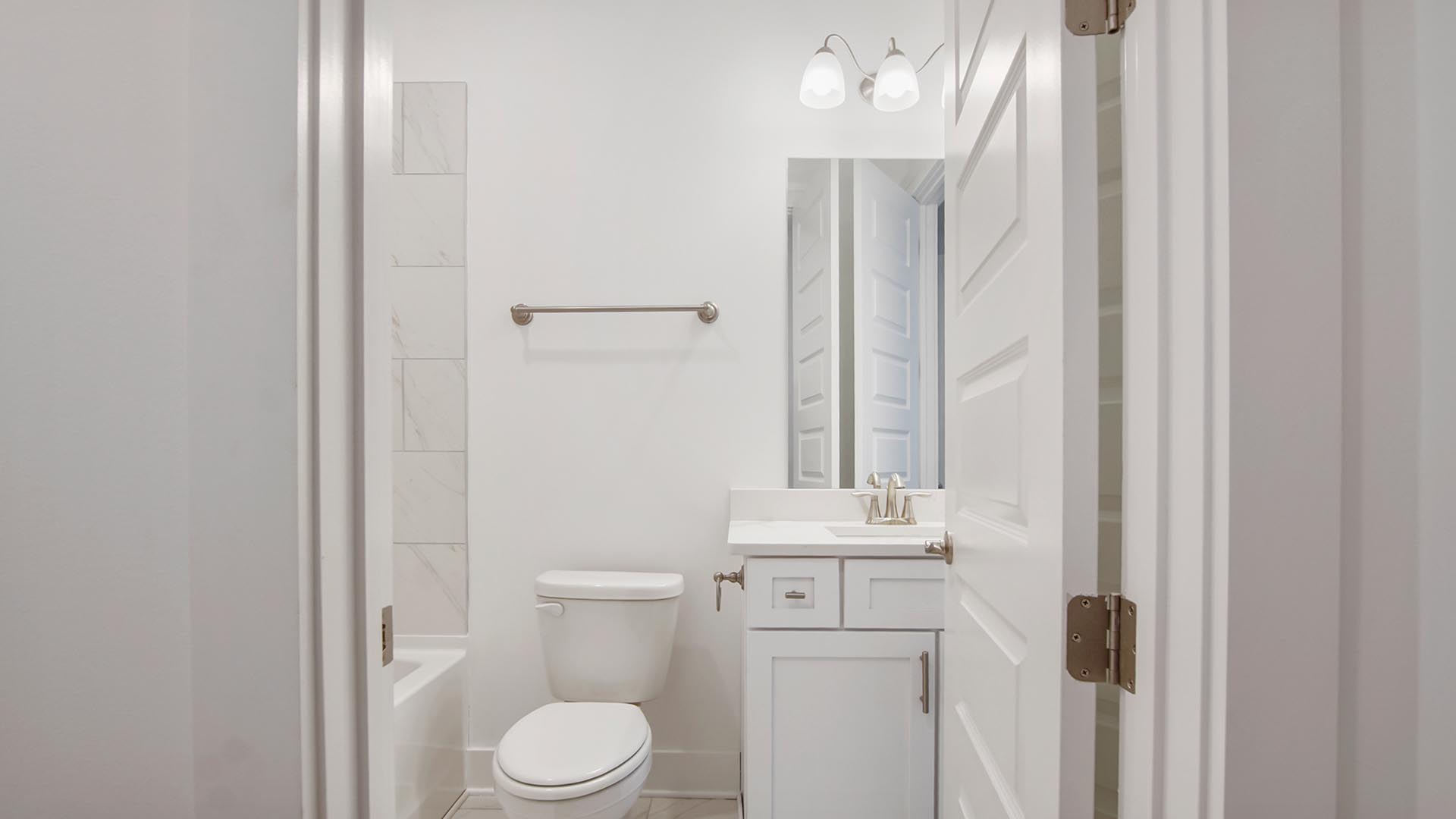 Private bath in bedroom four has a shower tub combination and tile floor