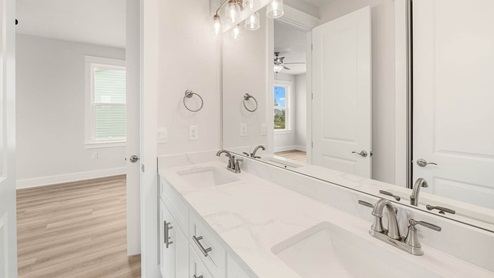 Bathroom with double-vanity and quartz countertops.