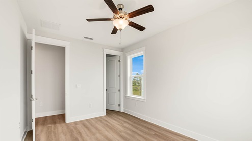 Bedroom with bathroom entrance and closet.