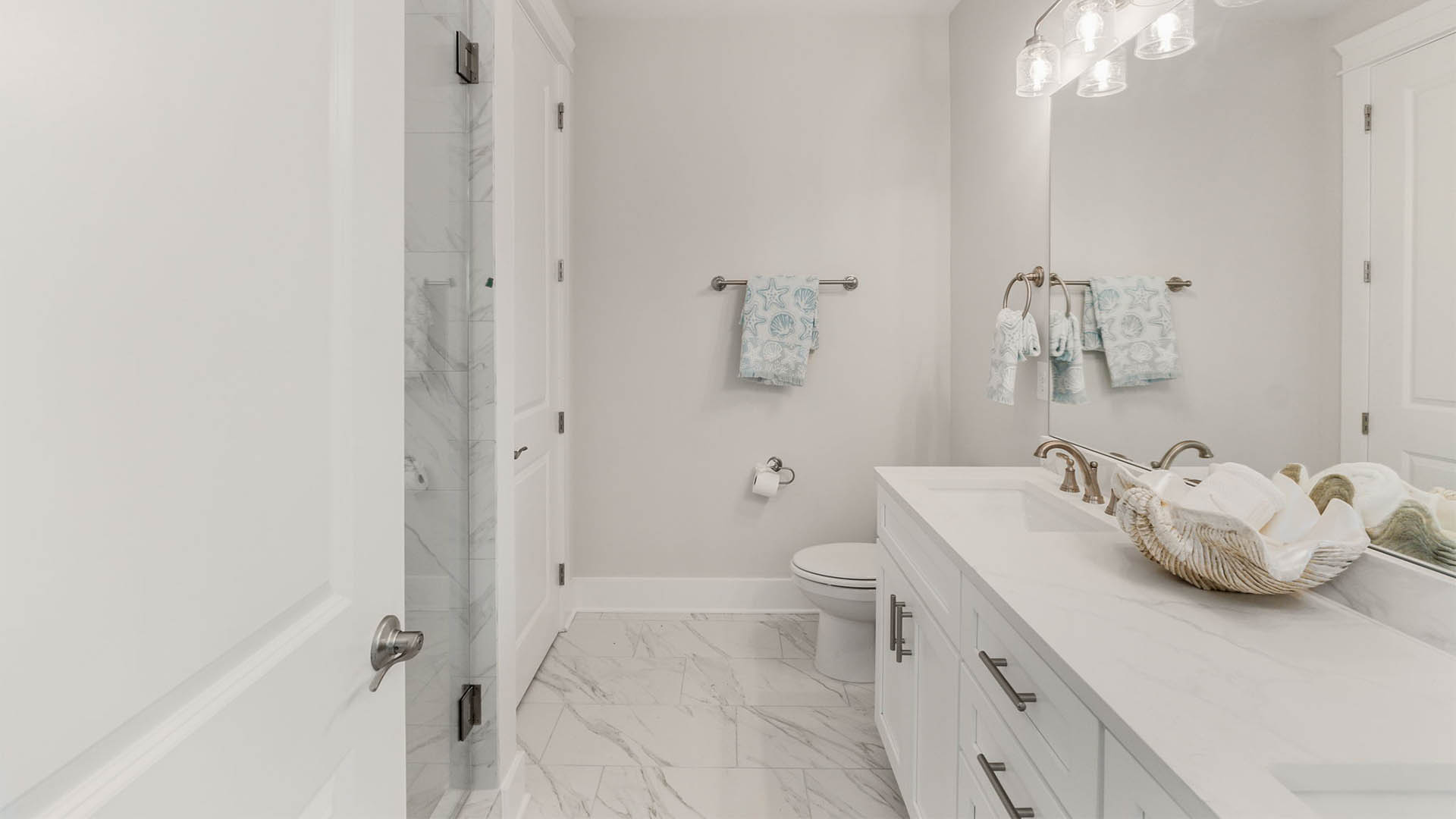 Bathroom with double-vanity and quartz countertops.