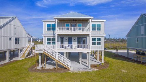 Luxury 2-story home on pilings with covered rear patios.