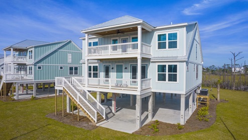 Luxury 2-story home on pilings with covered rear patios.
