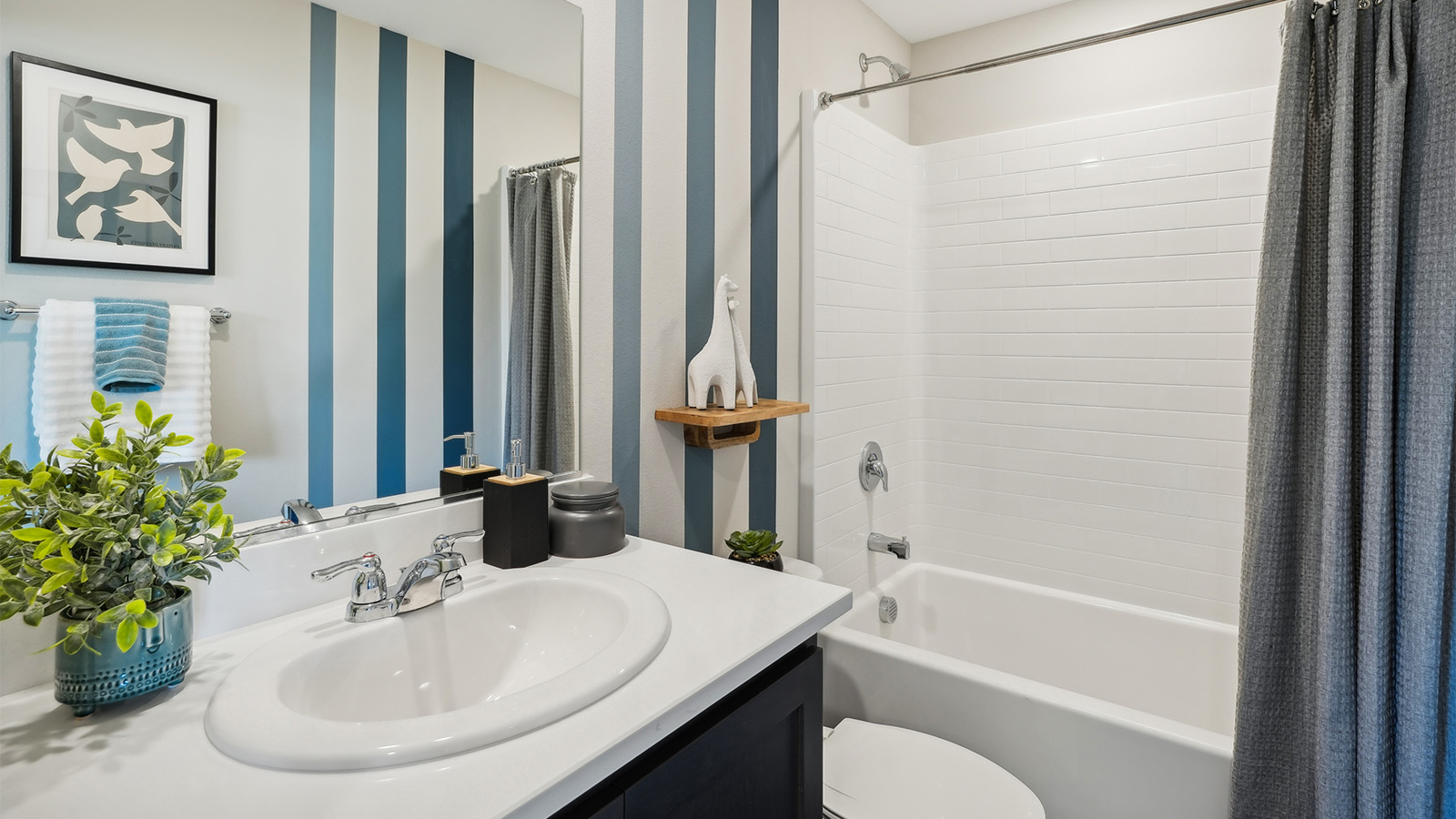 Secondary bathroom with vanity and tub shower combination