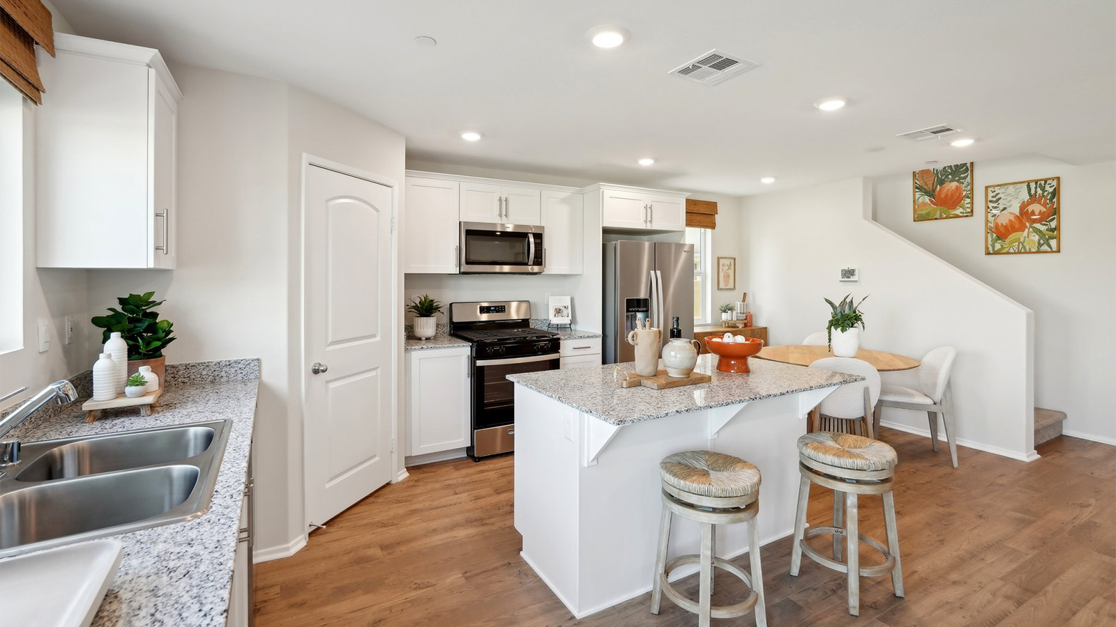 Modern kitchen with white cabinets granite countertops and stainless steel appliances