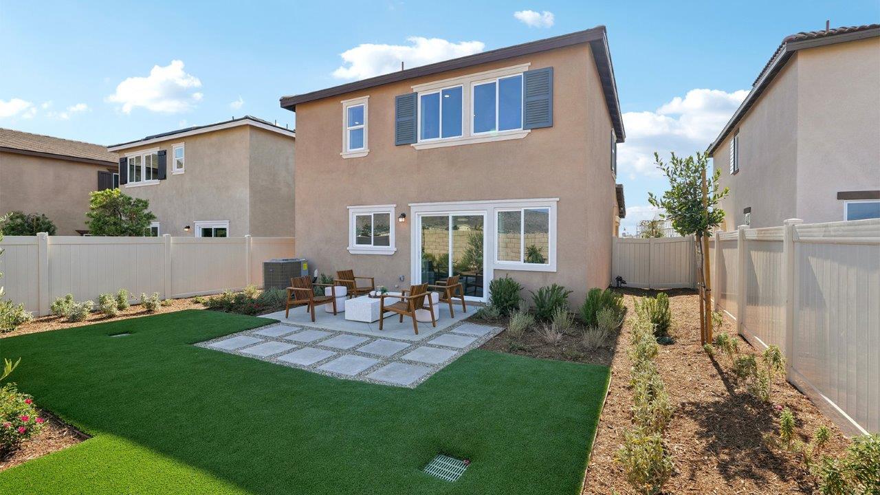 Spacious backyard with turf and seating area