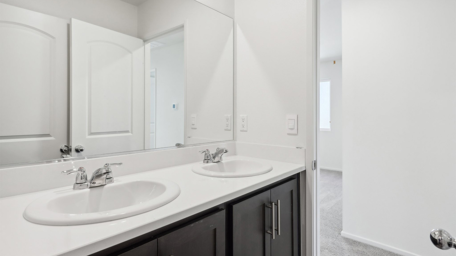Secondary bathroom with dual vanities