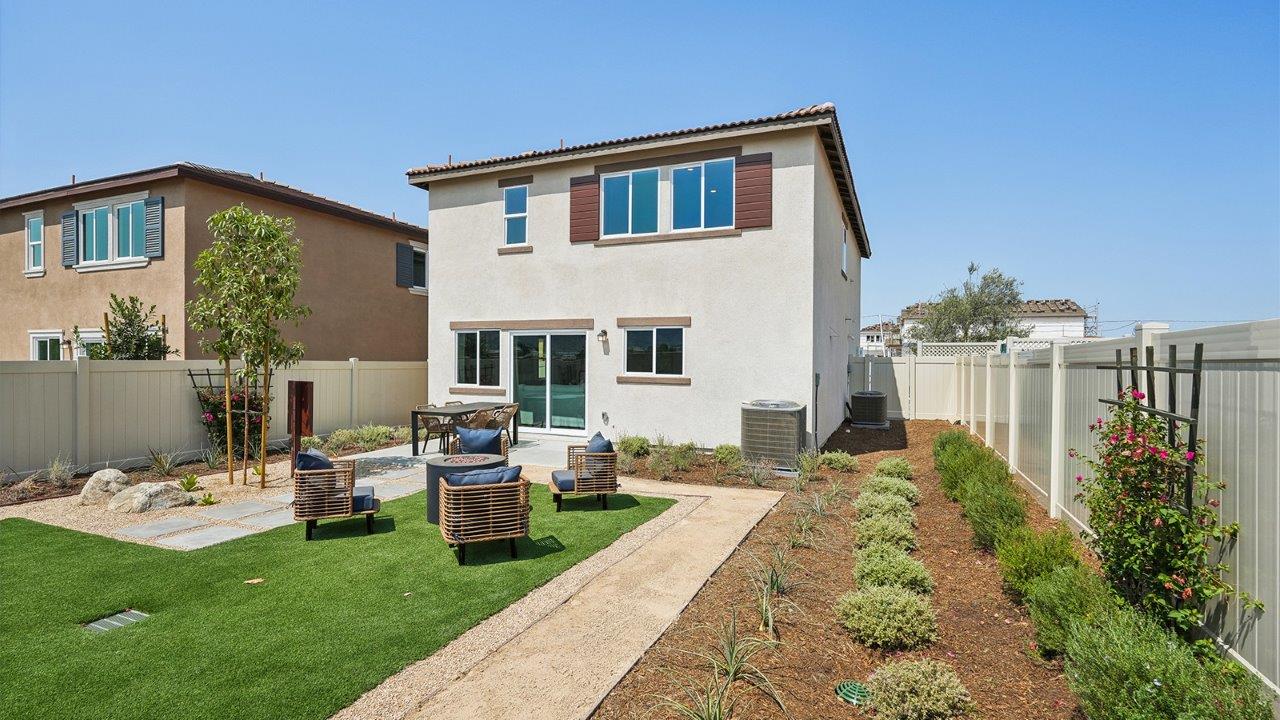 Spacious backyard with patio area and turf