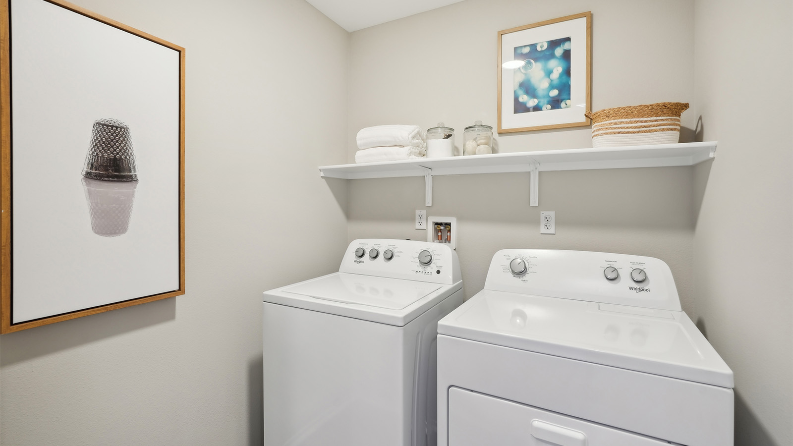 Laundry room with washer and dyer with upper shelf