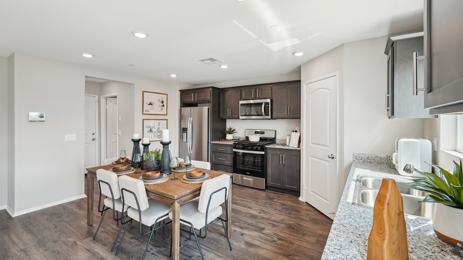 Open-concept kitchen with granite counters and stainless steel appliances