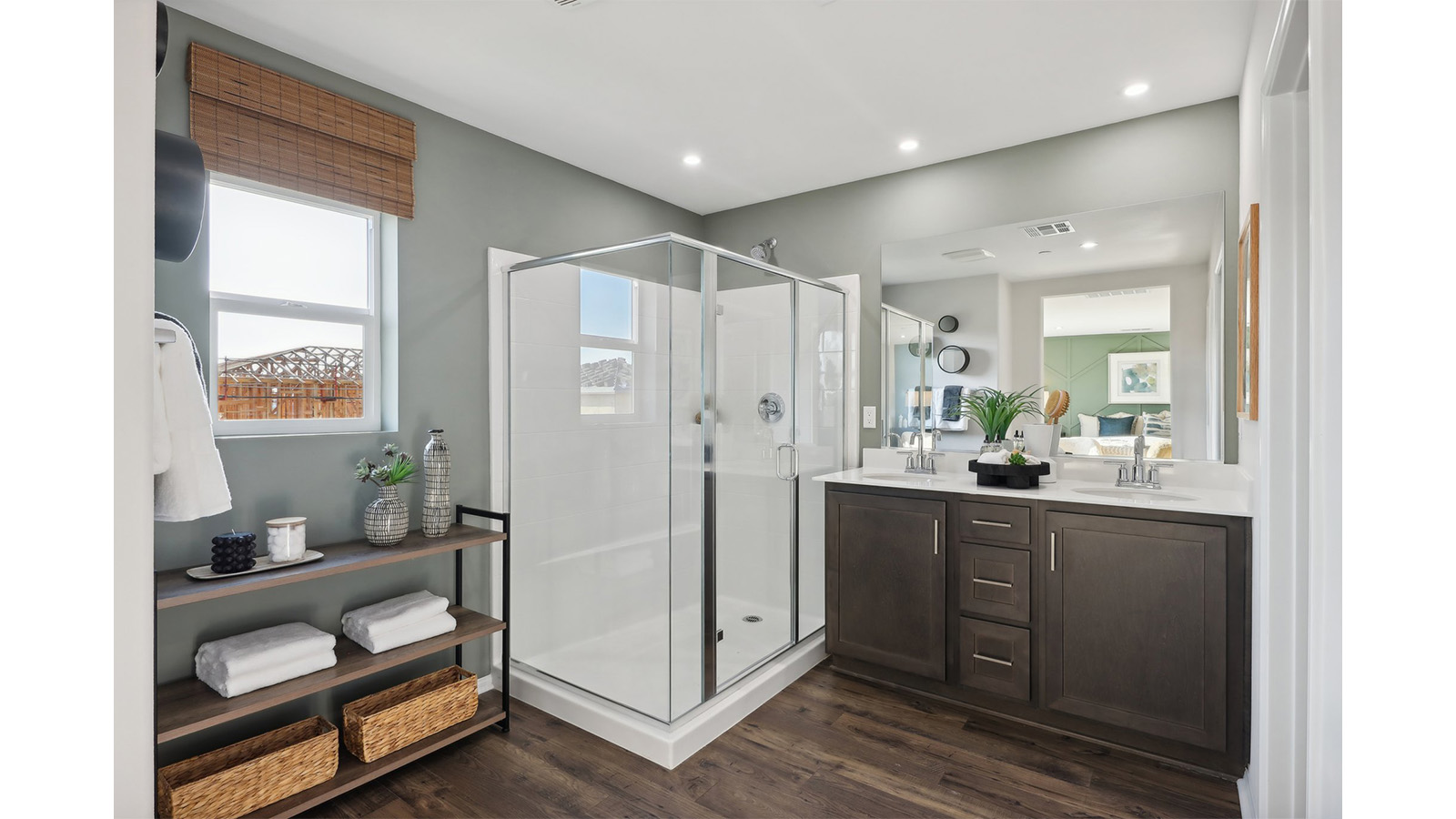Primary bathroom with dual vanities and shower