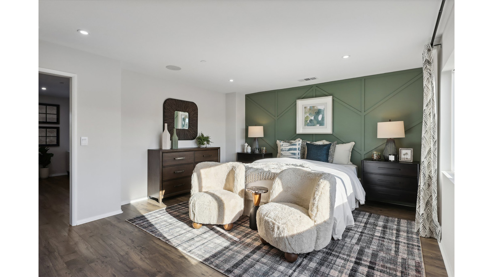 Primary bedroom with king bed and laminate flooring