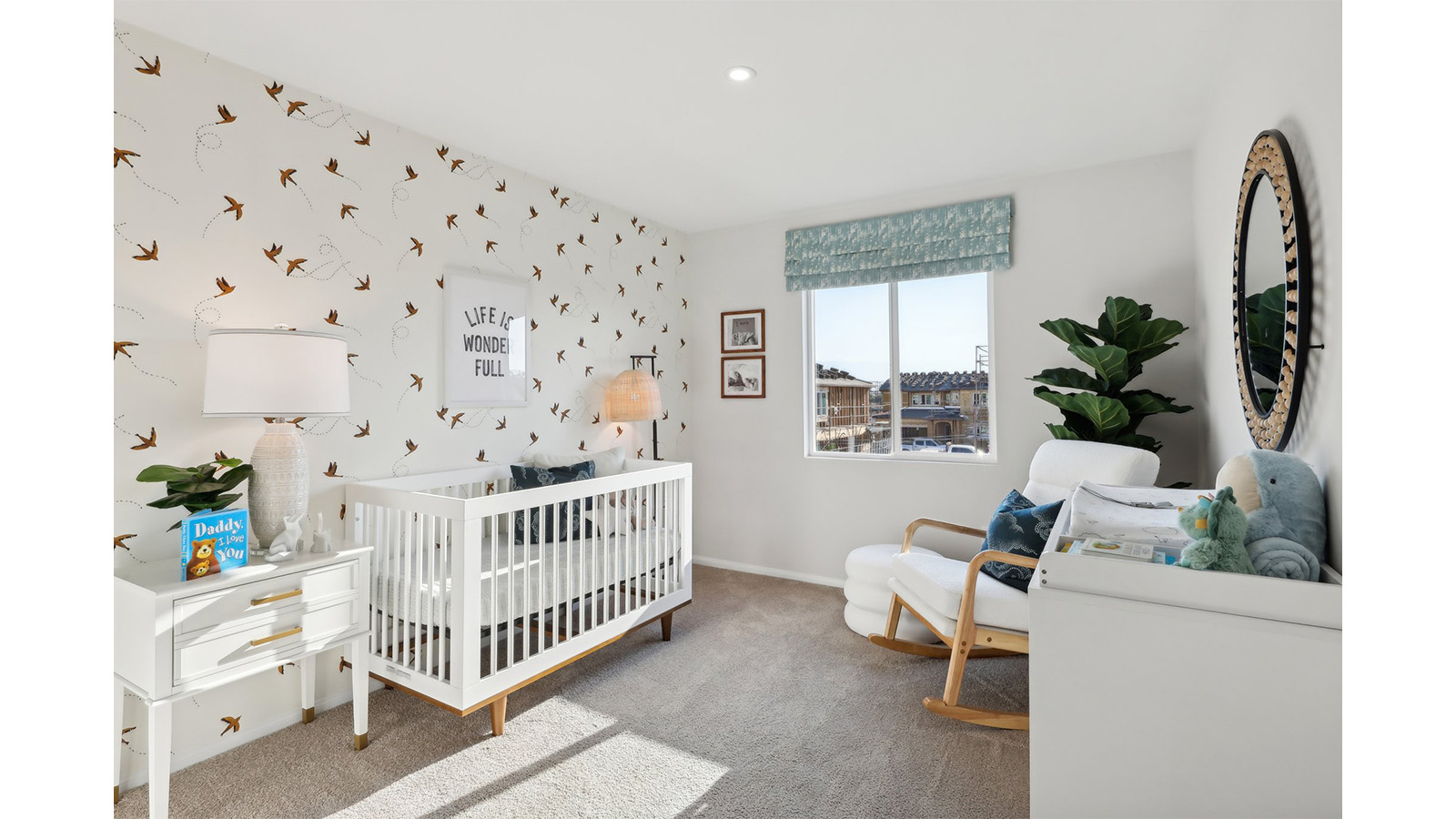 Secondary bedroom with crib and rocking chair