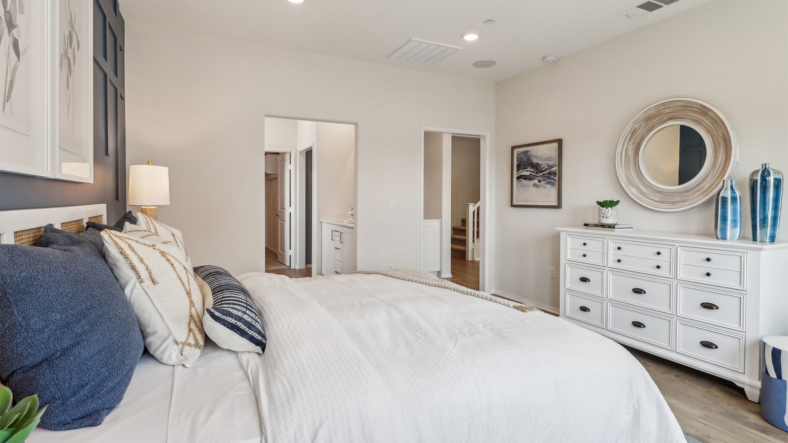 Primary bedroom with king bed and laminate flooring
