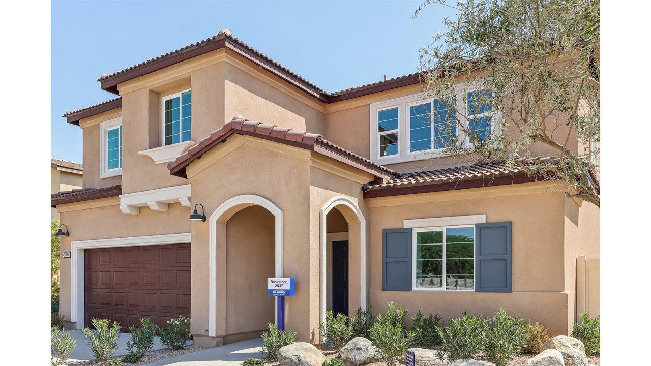 Two-story Italianate home with two-car garage and shutters