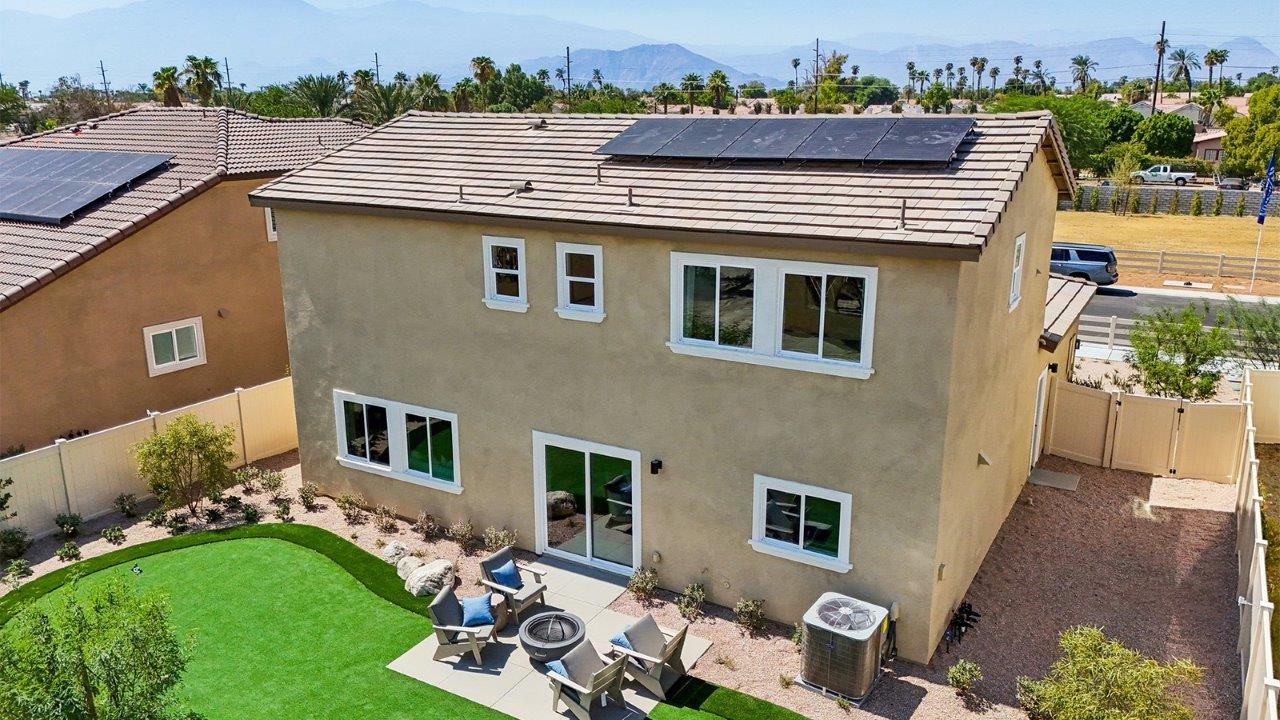 Spacious backyard with patio area and turf