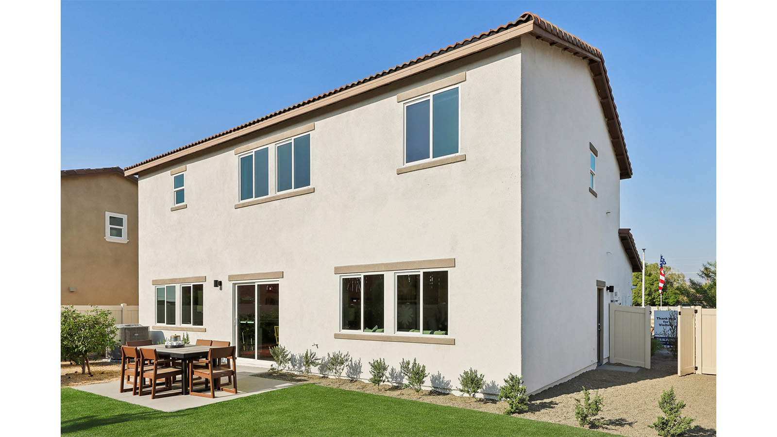 Spacious backyard with patio area and turf