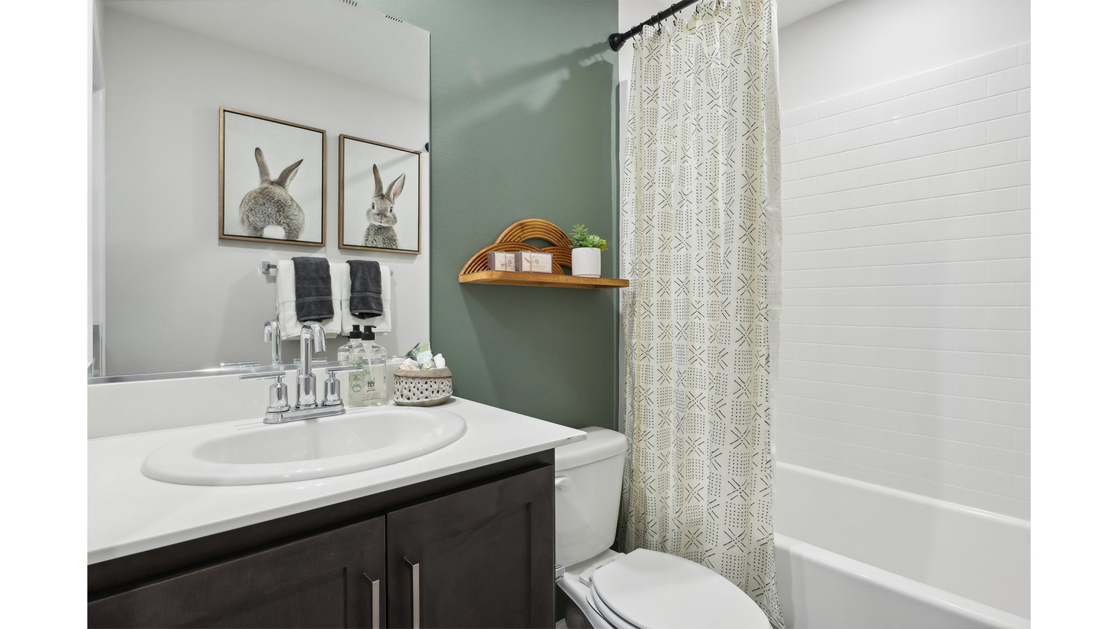 Secondary bathroom with vanity and tub shower combination