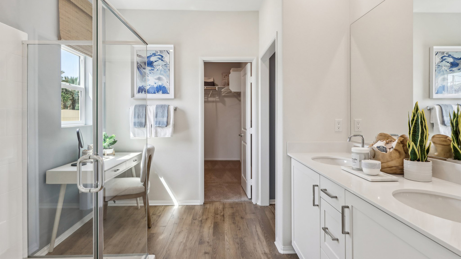 Primary bathroom with dual vanities and shower