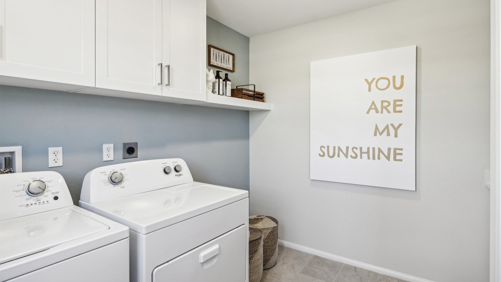 Laundry room with upper cabinet and shelf and washer and dryer