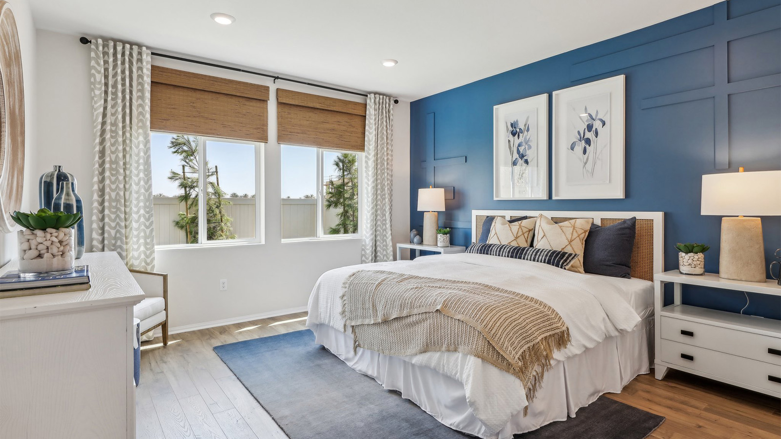 Primary bedroom with king bed and laminate flooring