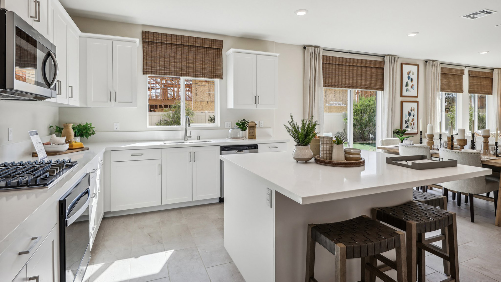 Modern kitchen with white cabinets quartz countertops and stainless steel appliances