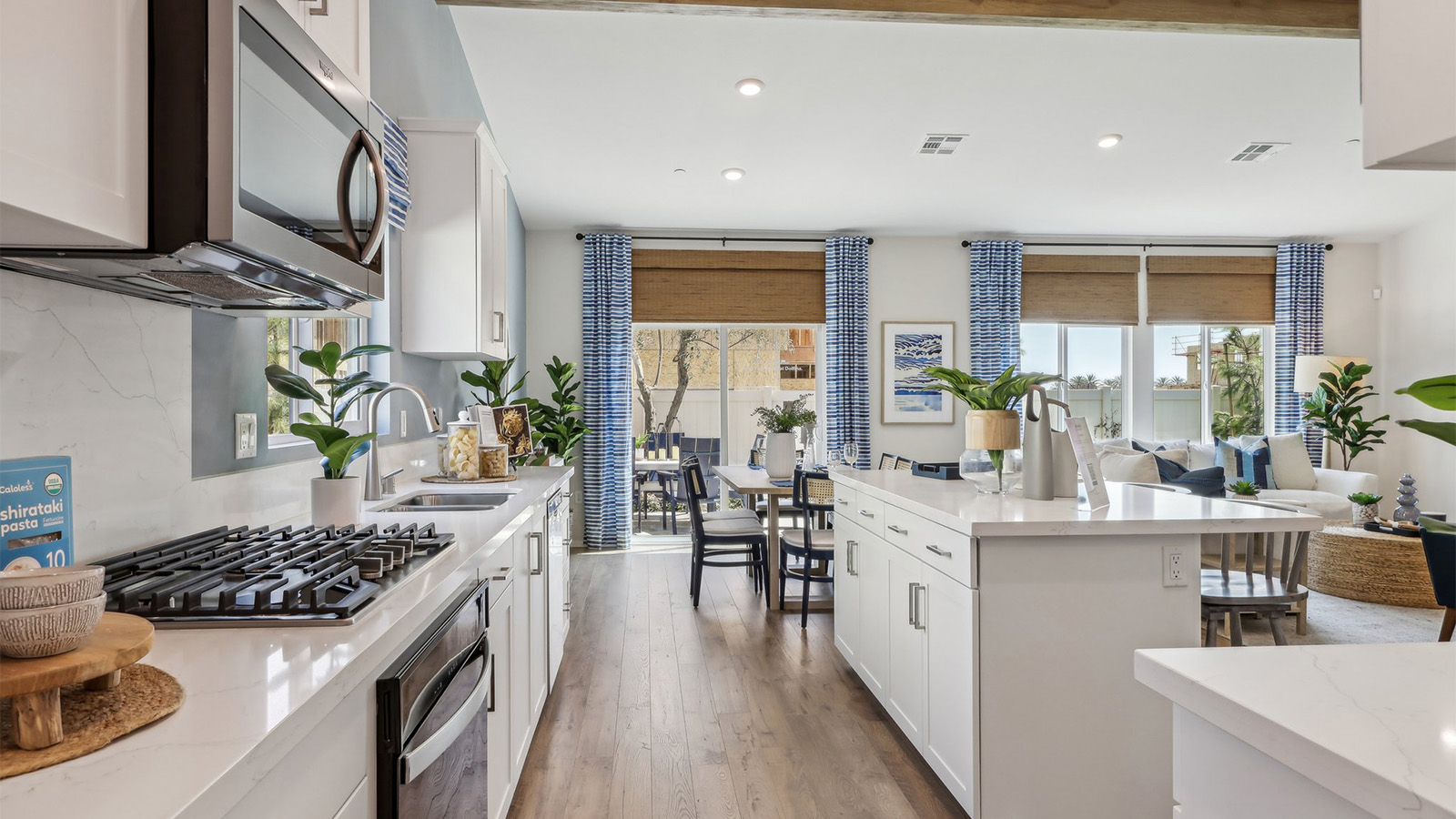 Spacious open-concept great room, dining room and kitchen with vaulted ceiling