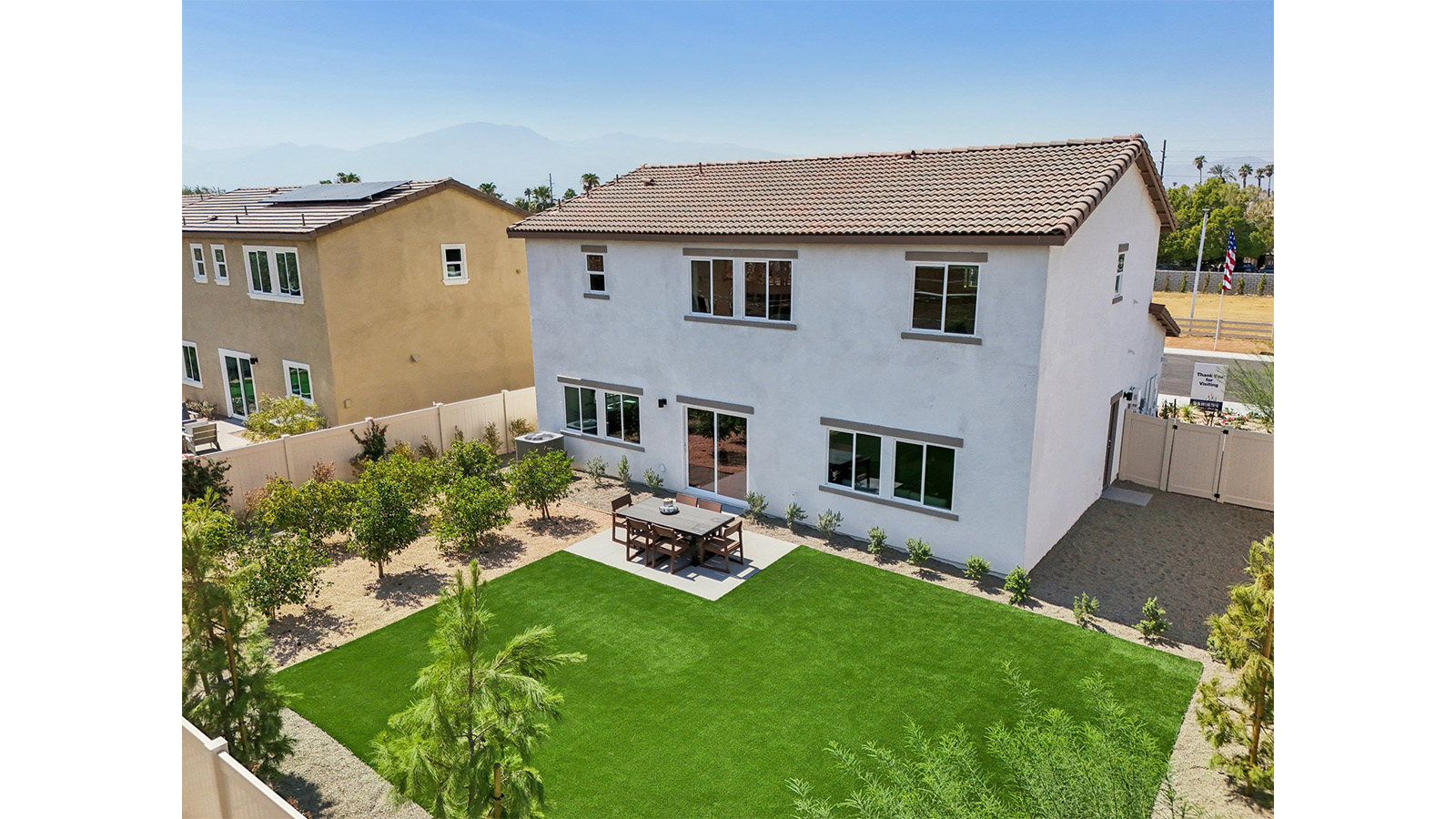 Spacious backyard with patio area and turf