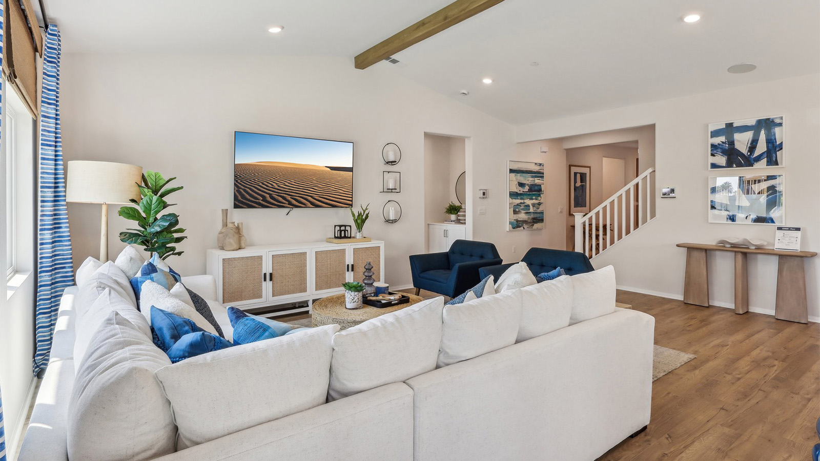 Spacious open-concept great room, dining room and kitchen with vaulted ceiling