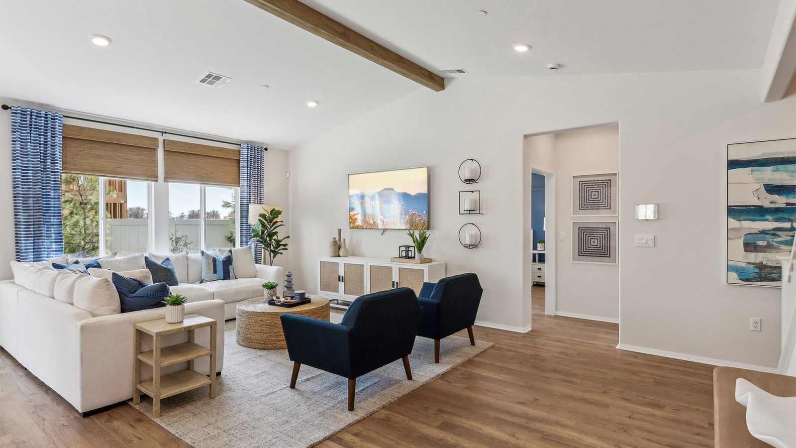 Spacious open-concept great room, dining room and kitchen with vaulted ceiling