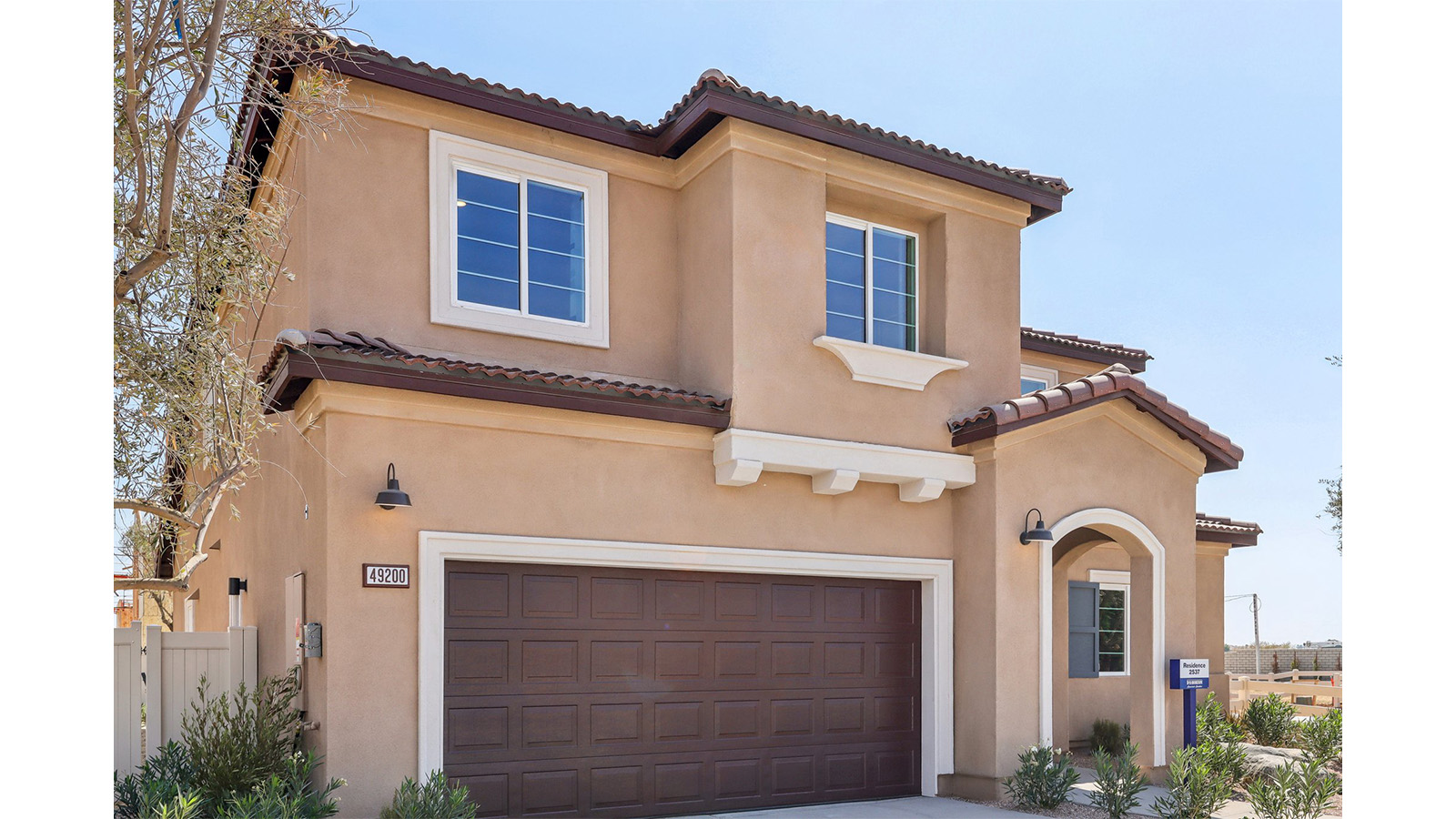 Two-story Italianate home with shutters and two-car garage