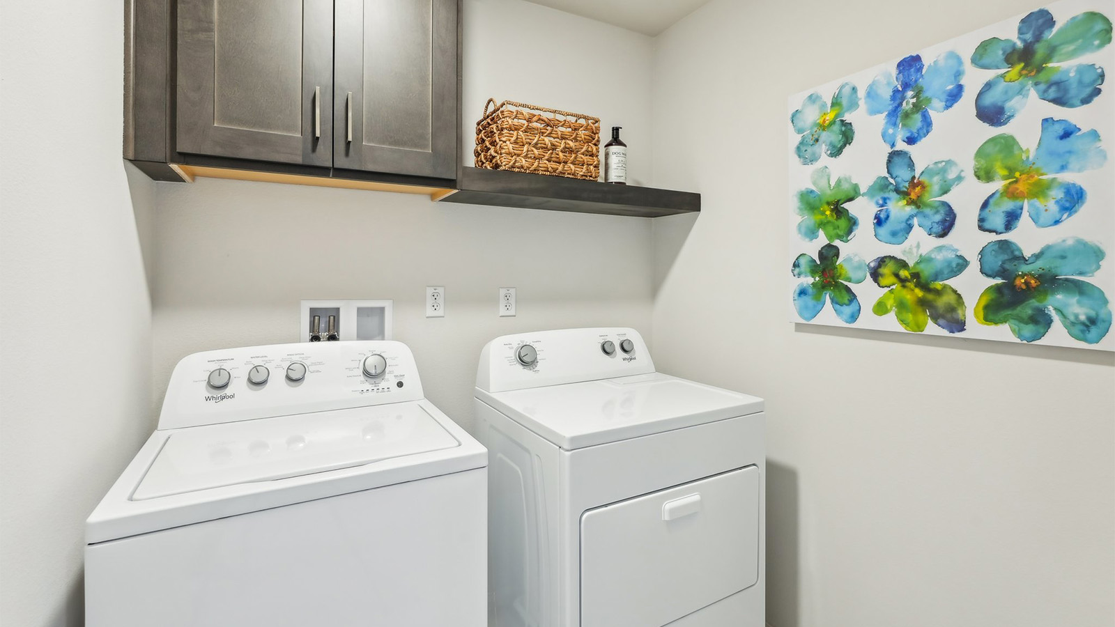 Laundry with washer, dryer, and upper cabinet and shelf