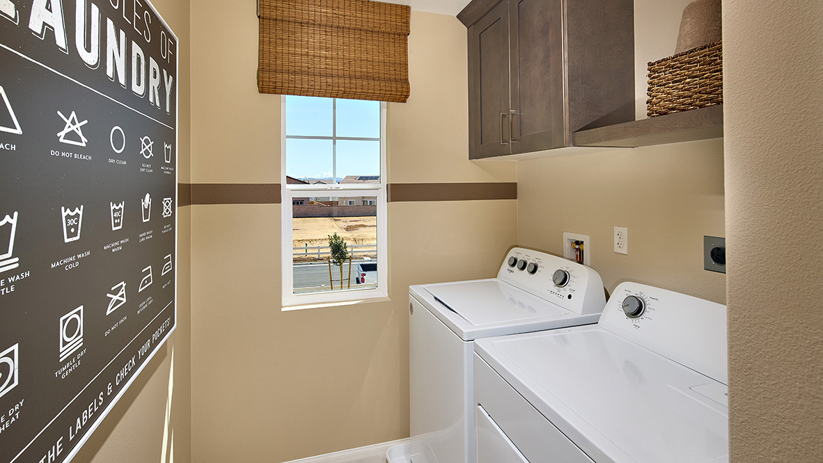 Laundry room with upper shelf and cabinet