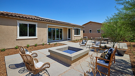 Spacious open-concept backyard with patio area and firepit