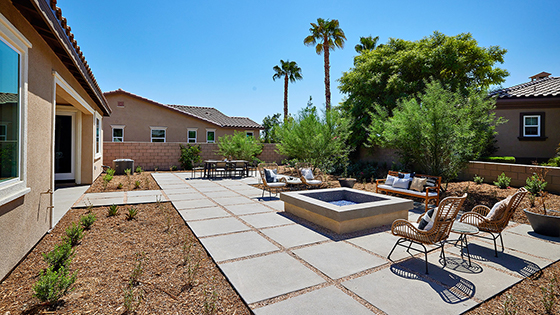 Spacious open-concept backyard with patio area and firepit