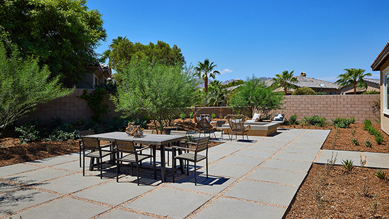 Spacious open-concept backyard with patio area