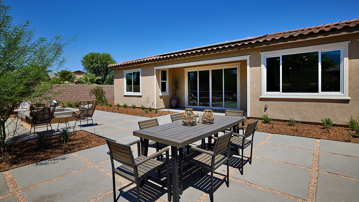 Spacious open-concept backyard with patio area