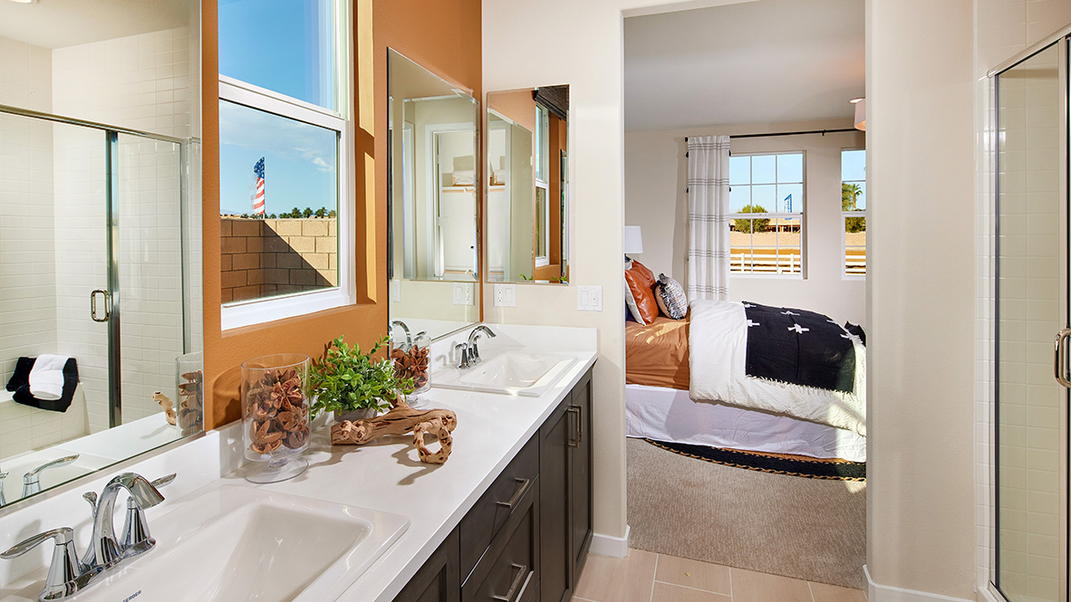 Bathroom with double sinks and walk-in shower