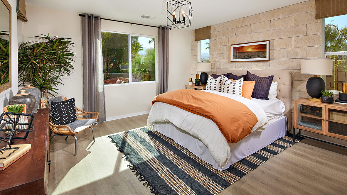 Primary bedroom with king bed and laminate flooring