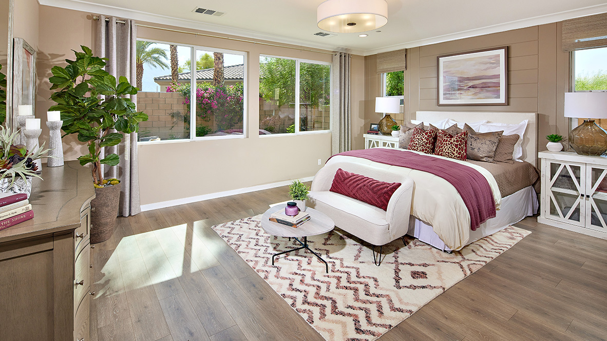 Primary bedroom with king bed and laminate flooring