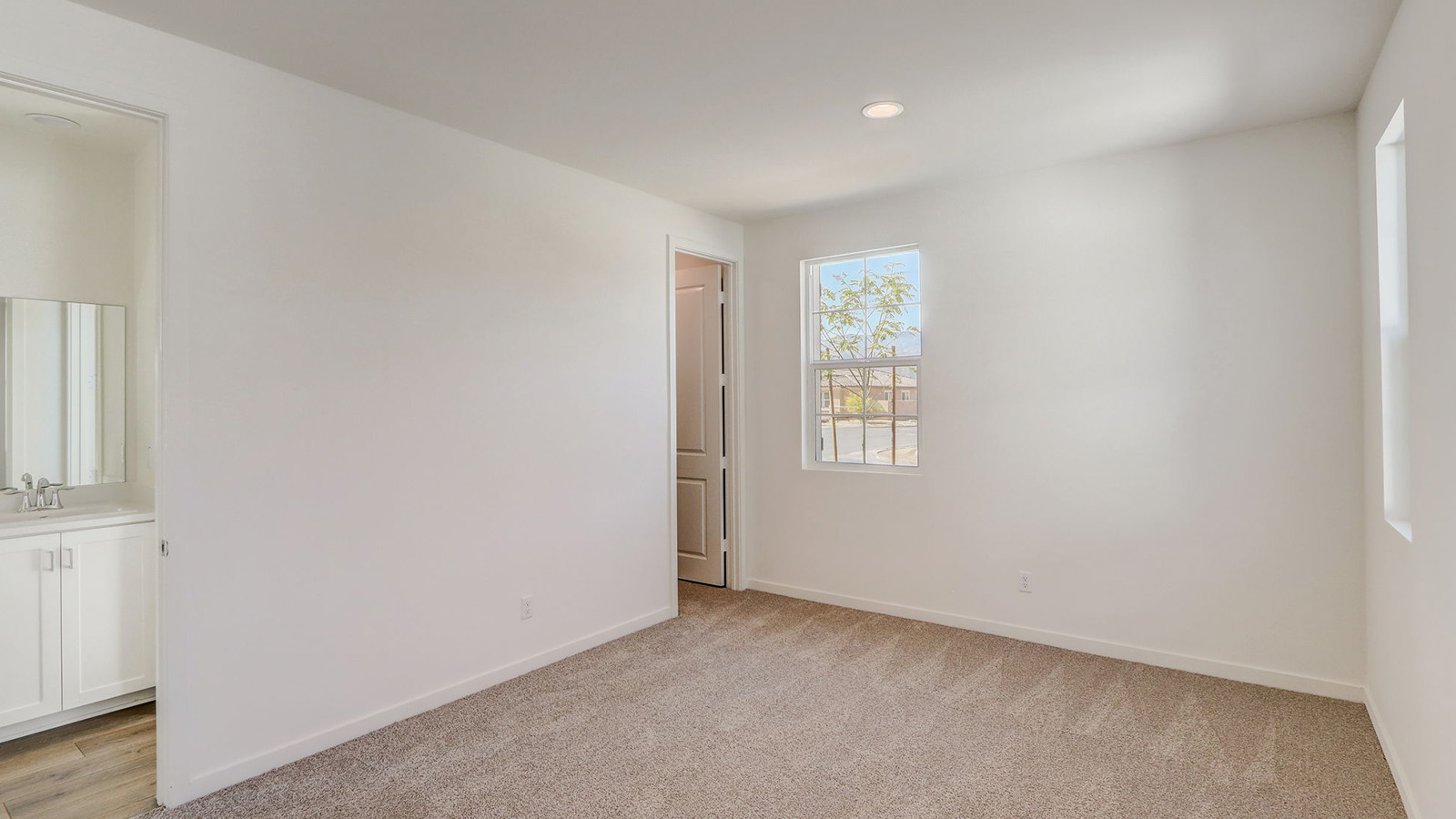 Secondary bedroom with carpet