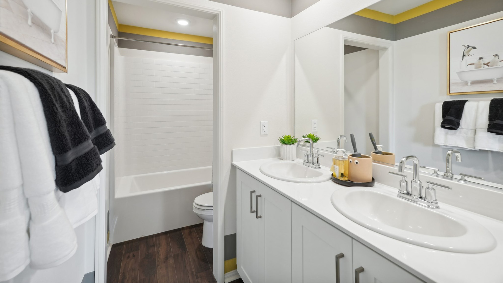 secondary bathroom with vanities and separate tub shower