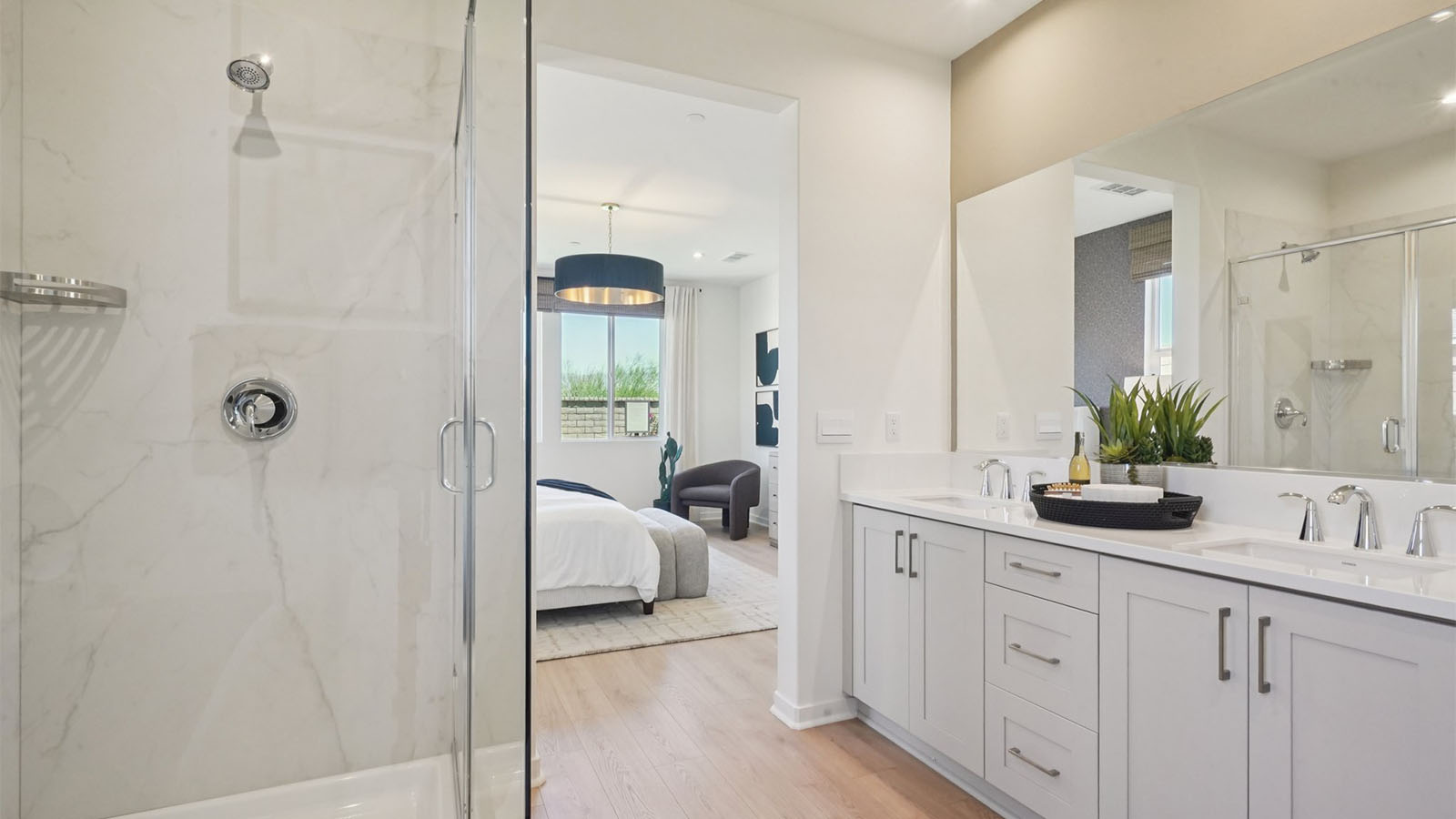 Primary bathroom with dual vanities and shower