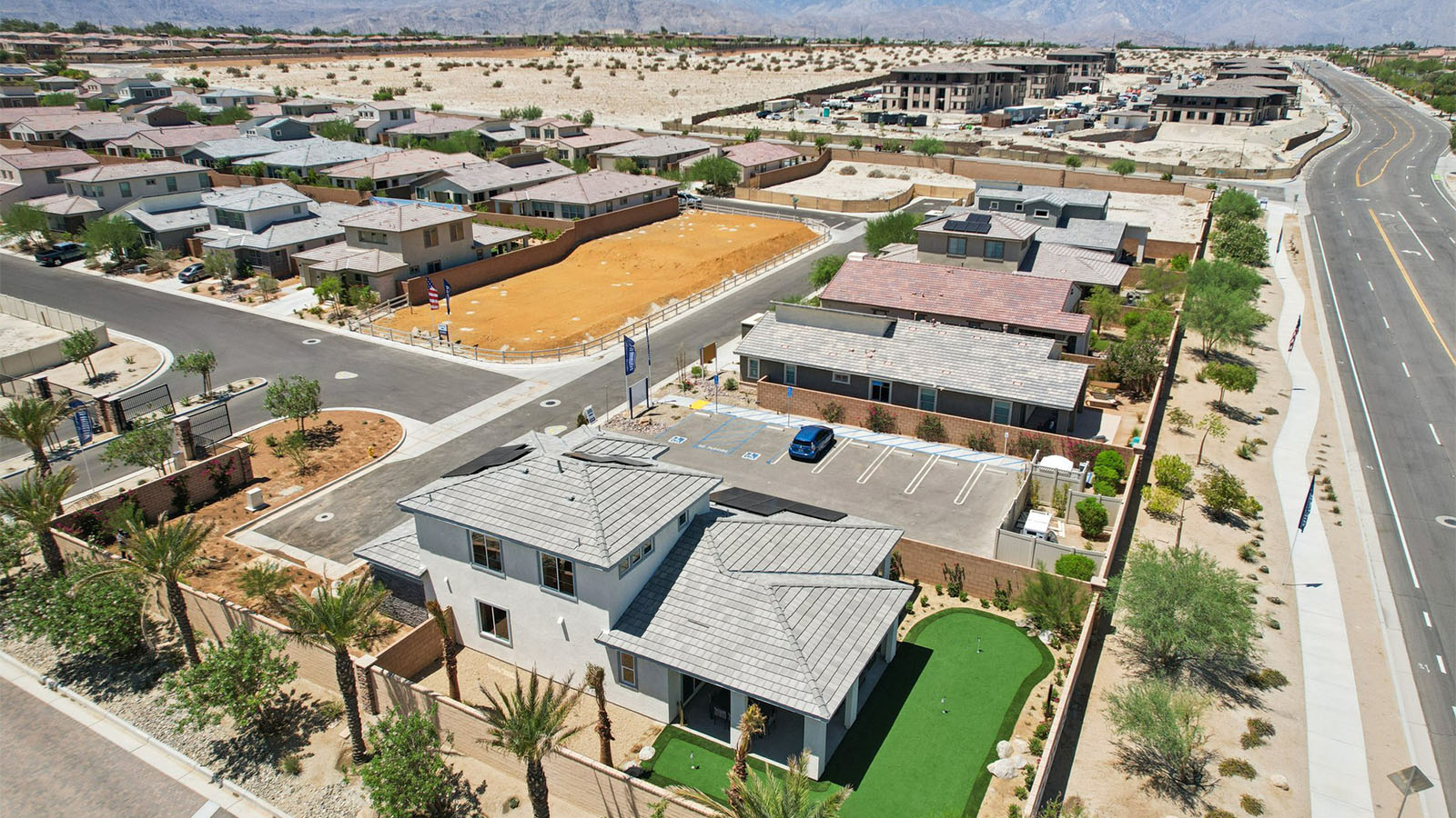Aerial view of home with solar panels and turf backyard